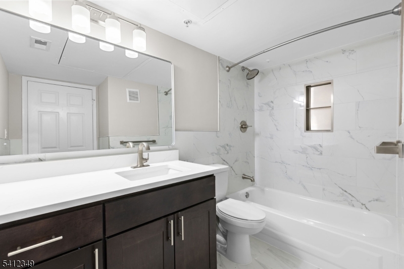 690 Route 23 Wayne Nj 07470, Unit R2 Wayne, NJ 07470 - Photo 5 of 9 a bathroom with a sink a toilet and shower