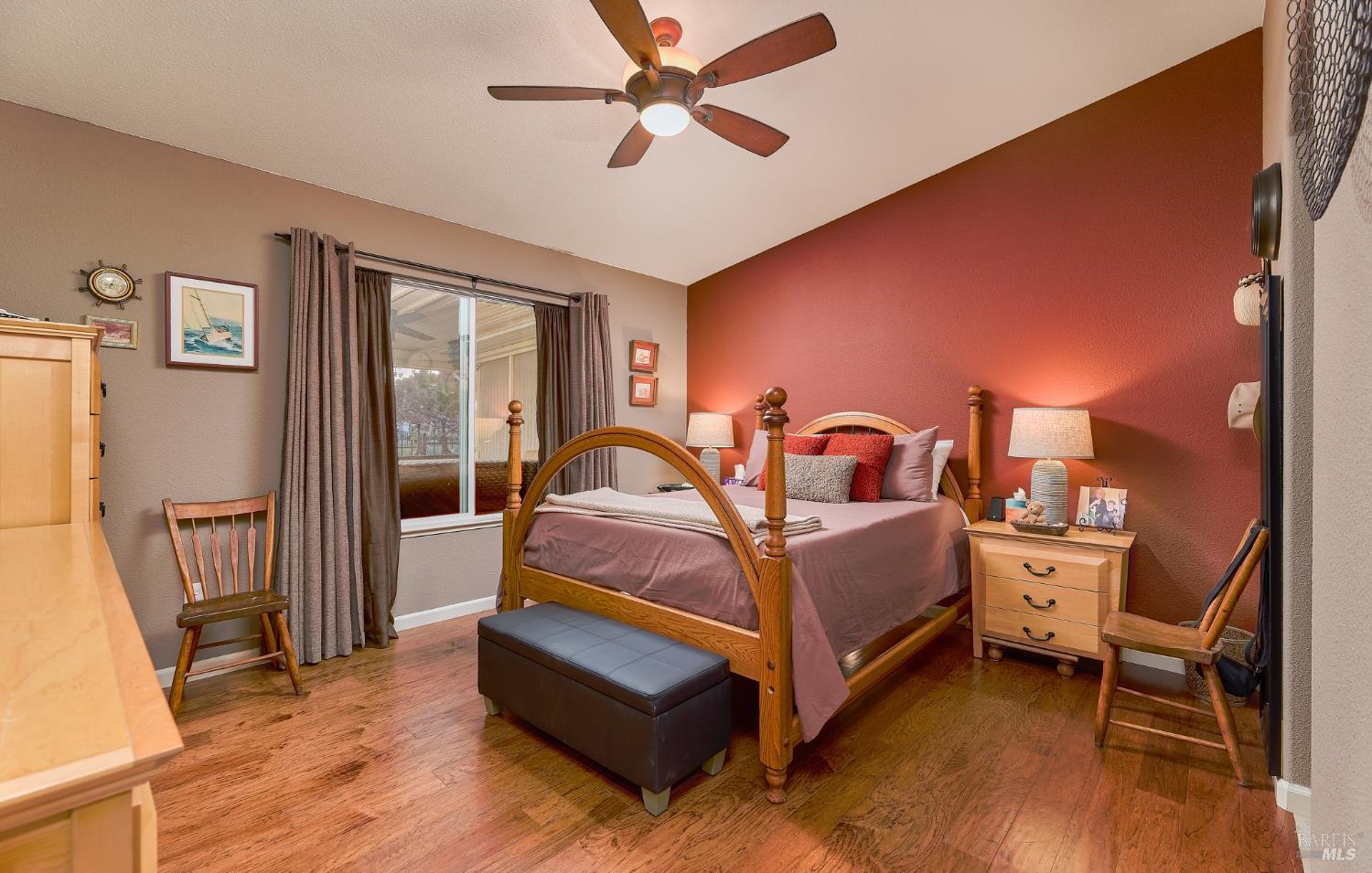 402 Riverwood Lane Rio Vista, CA 94571 - Photo 18 of 31 a spacious bedroom with a bed and a chandelier