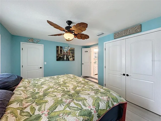 a bathroom with a granite countertop sink a mirror and shower