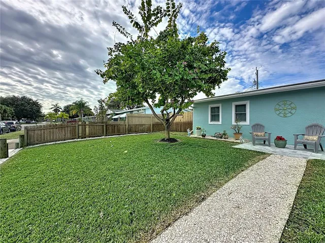 a backyard of a house with table and chairs