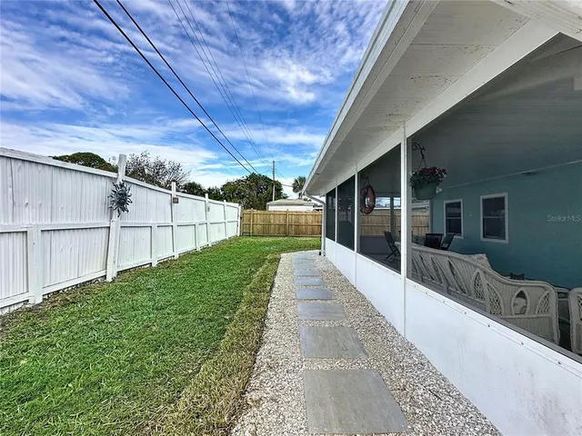 a view of a house with pool and a yard