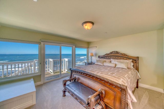 a bedroom with a bed and glass window