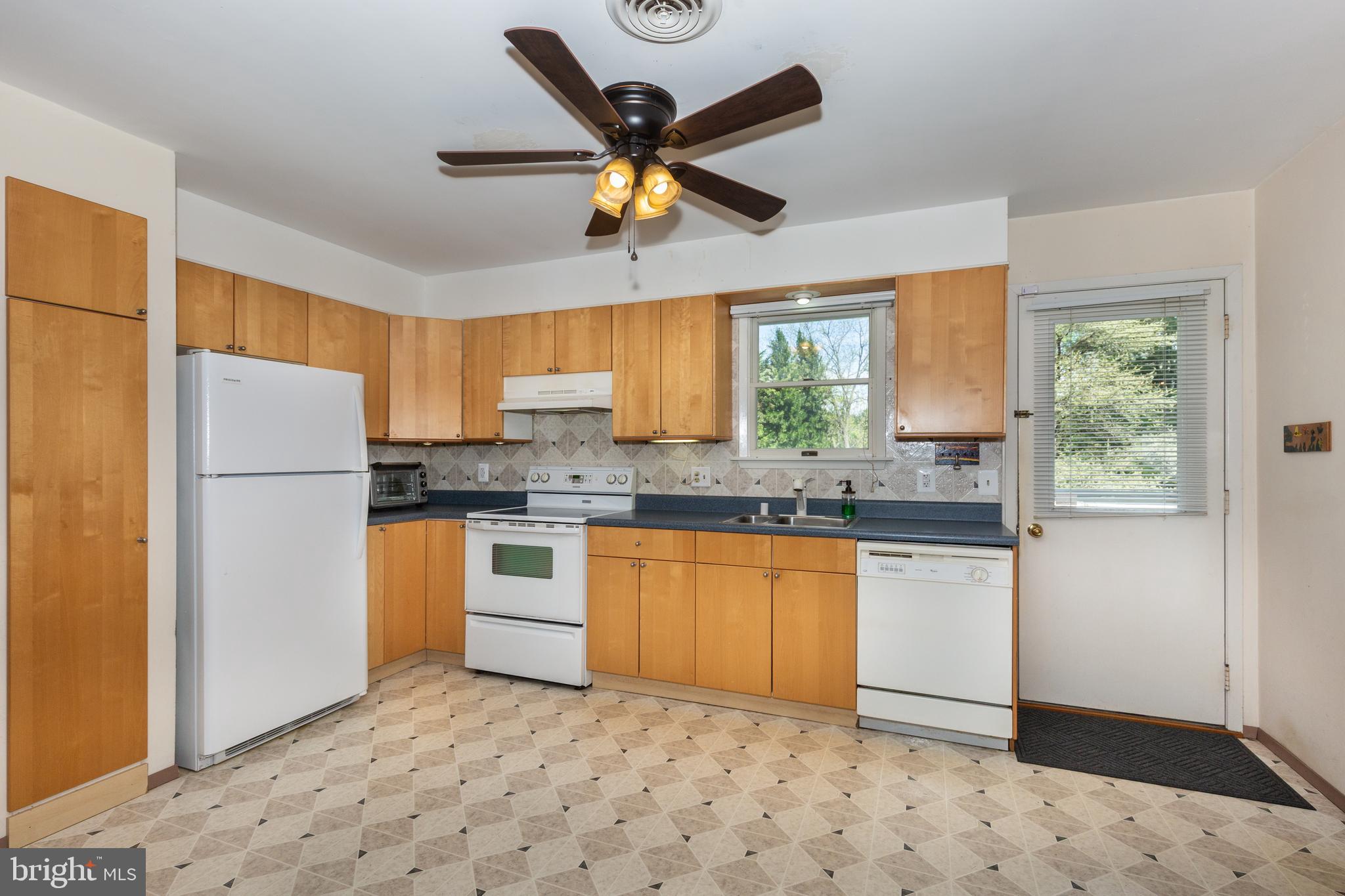 4300 Maple Grove Road Hampstead, MD 21074 - Photo 11 of 58 a kitchen with stainless steel appliances granite countertop a refrigerator sink and cabinets