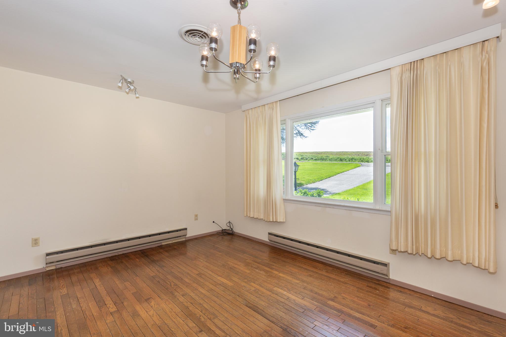 4300 Maple Grove Road Hampstead, MD 21074 - Photo 3 of 58 an empty room with wooden floor and windows