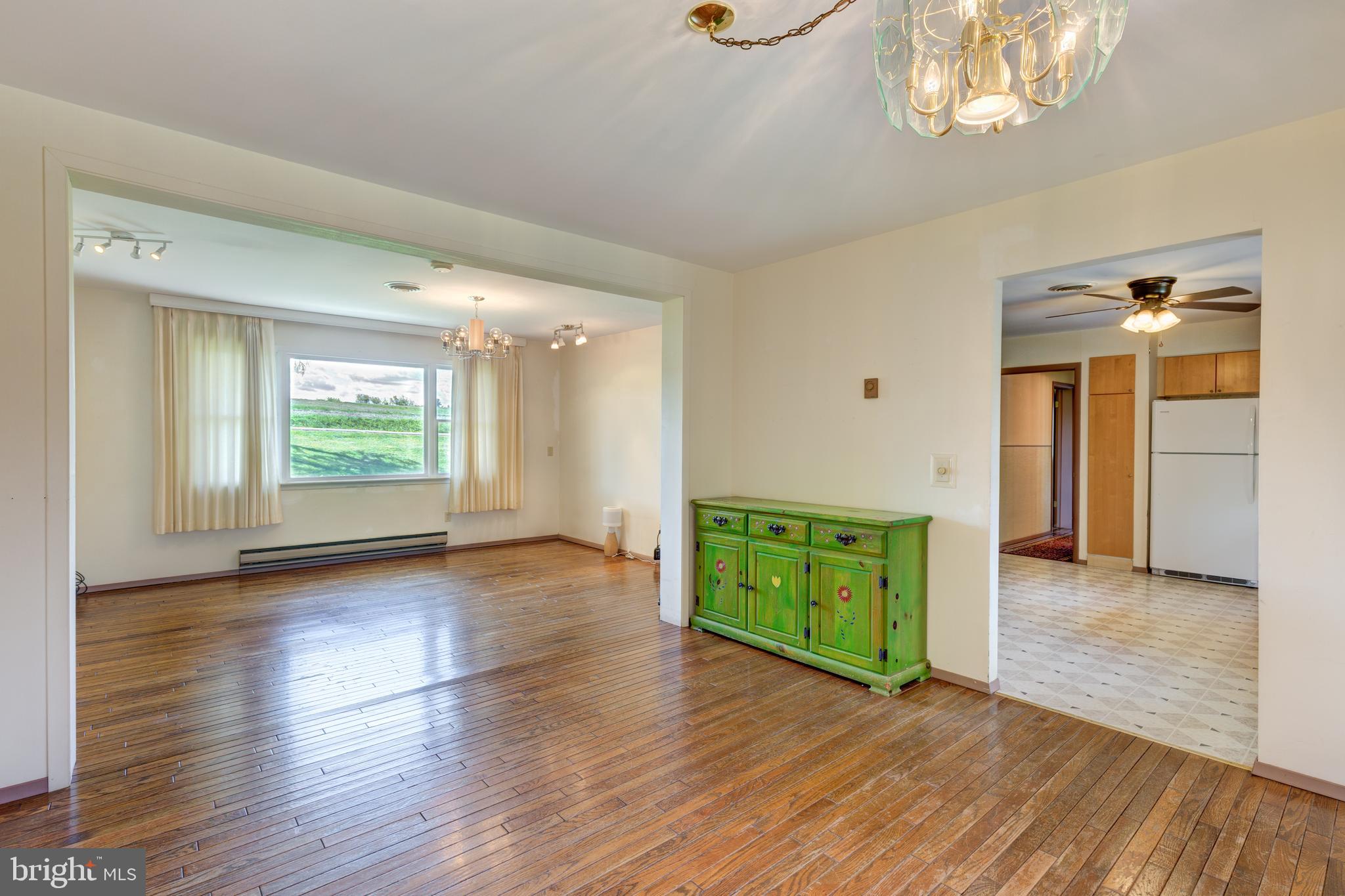 4300 Maple Grove Road Hampstead, MD 21074 - Photo 6 of 58 an empty room with wooden floor cabinet and windows