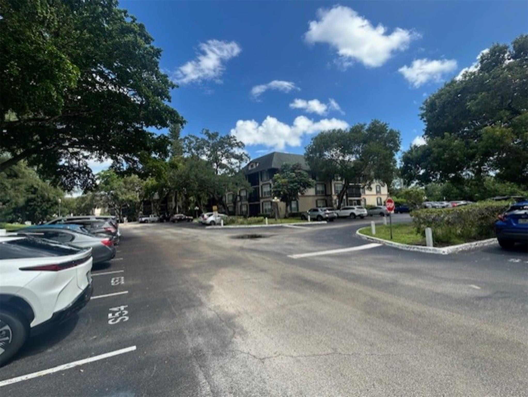 3720 Inverrary Drive, Unit 1T Lauderhill, FL 33319 - Photo 34 of 36 a view of a street with cars parked