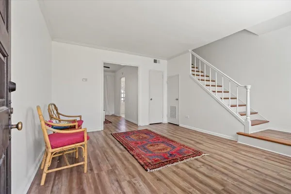 a living room with a rug and a chair