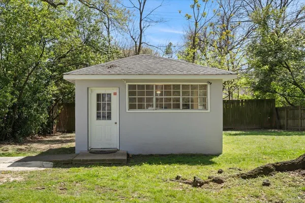 a house that has a tree in front of the house