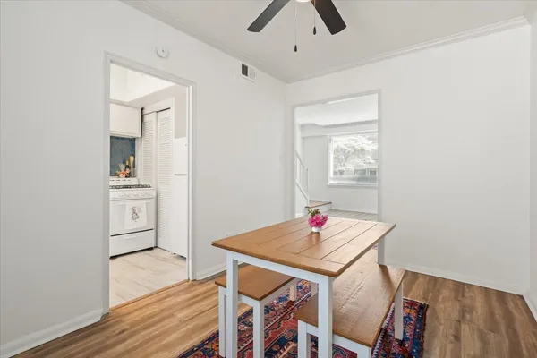 a view of a dining room with furniture and wooden floor