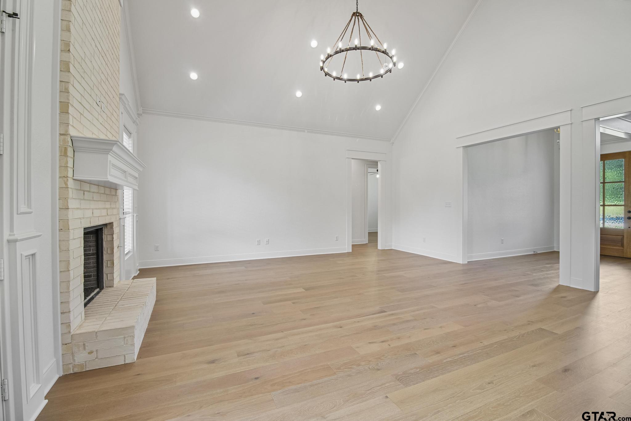16511 Cooper Way Flint, TX 75762 - Photo 11 of 44 a view of empty room with wooden floor and fireplace