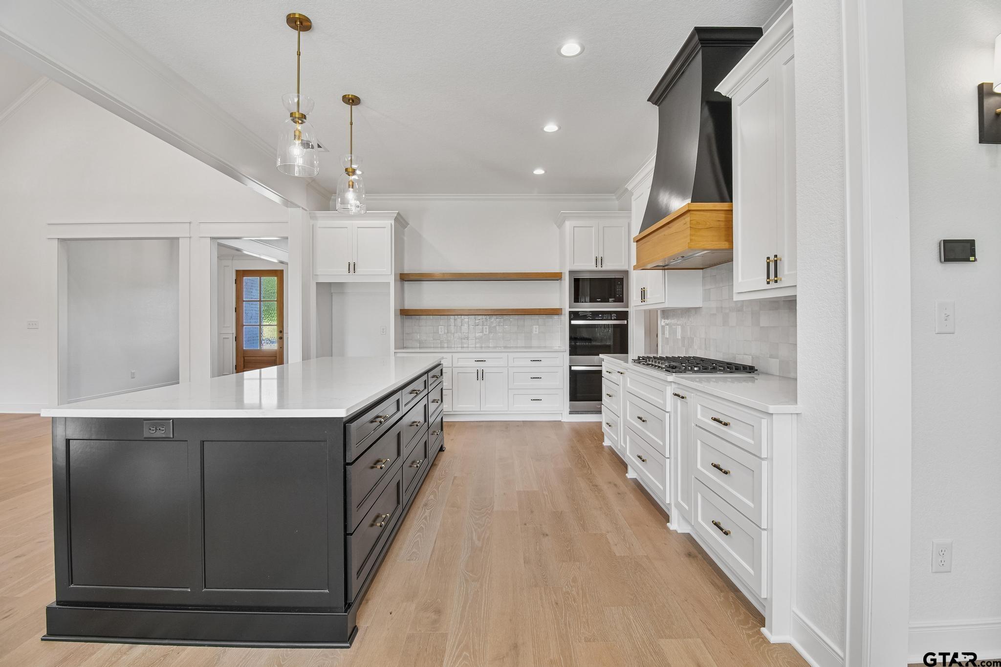 16511 Cooper Way Flint, TX 75762 - Photo 14 of 44 a kitchen with stainless steel appliances kitchen island granite countertop a sink and a refrigerator