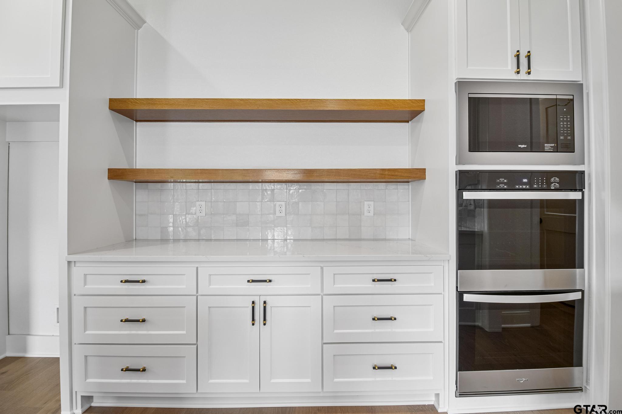 16511 Cooper Way Flint, TX 75762 - Photo 16 of 44 a kitchen with white cabinets and stainless steel appliances