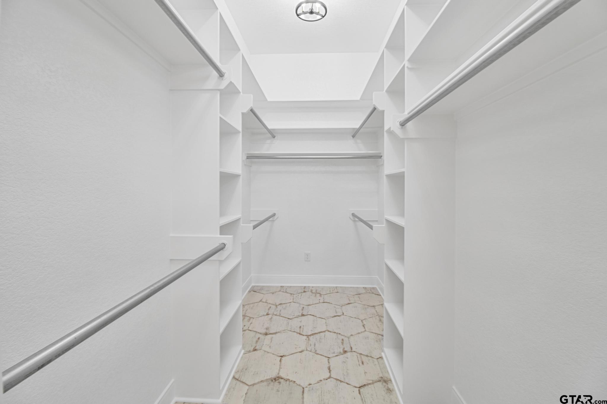 16511 Cooper Way Flint, TX 75762 - Photo 17 of 44 a view of walk in closet with empty racks