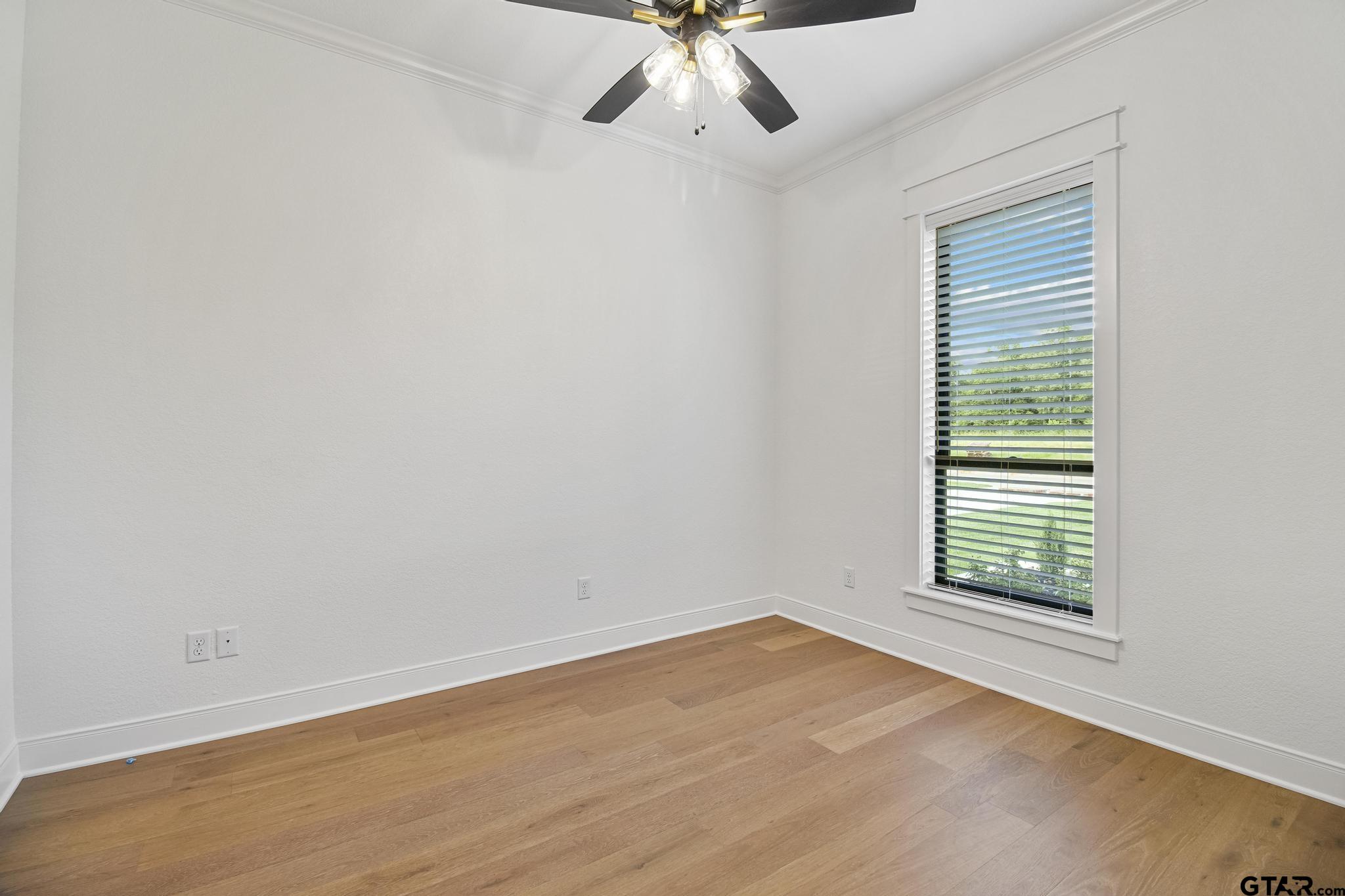 16511 Cooper Way Flint, TX 75762 - Photo 32 of 44 an empty room with a window and a ceiling fan