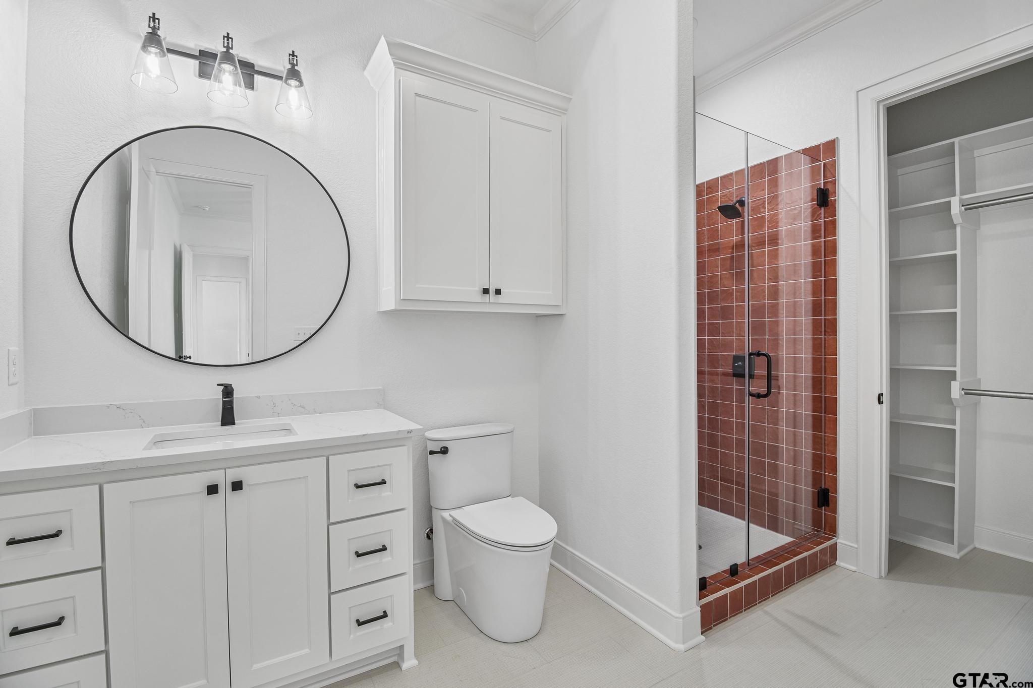 16511 Cooper Way Flint, TX 75762 - Photo 39 of 44 a bathroom with a toilet a sink and a mirror
