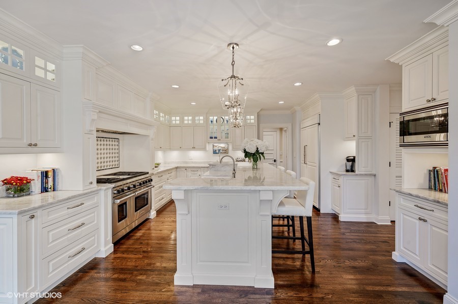 29 Woodley Road Winnetka, IL 60093 - Photo 19 of 65 a large kitchen with cabinets wooden floor and stainless steel appliances
