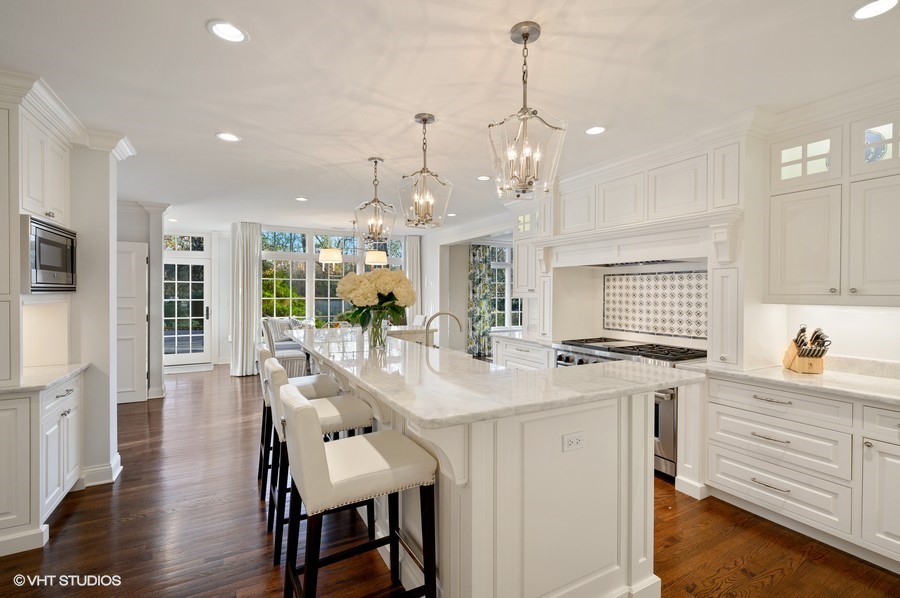 29 Woodley Road Winnetka, IL 60093 - Photo 22 of 65 a large kitchen with kitchen island a large island in it