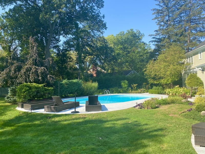 29 Woodley Road Winnetka, IL 60093 - Photo 28 of 65 a view of a swimming pool with a yard