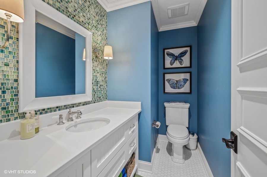 29 Woodley Road Winnetka, IL 60093 - Photo 39 of 65 a bathroom with a sink toilet and a mirror