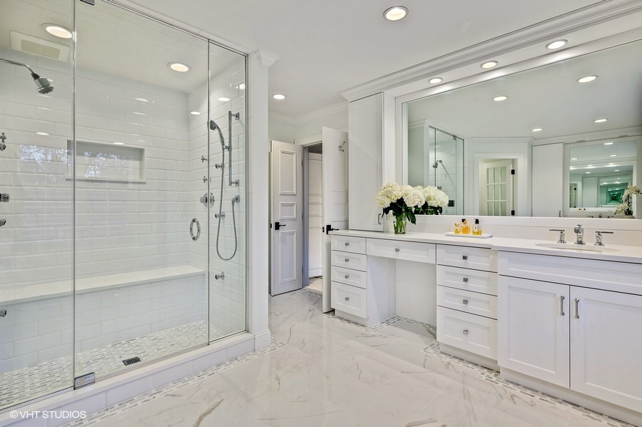 29 Woodley Road Winnetka, IL 60093 - Photo 44 of 65 a bathroom with a shower sink and a mirror