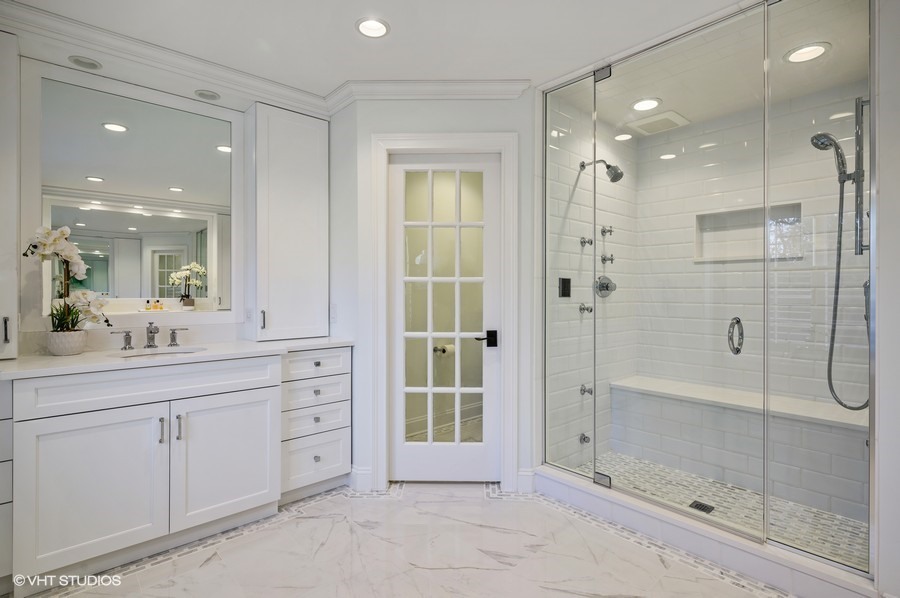 29 Woodley Road Winnetka, IL 60093 - Photo 45 of 65 a bathroom with a shower sink and mirror