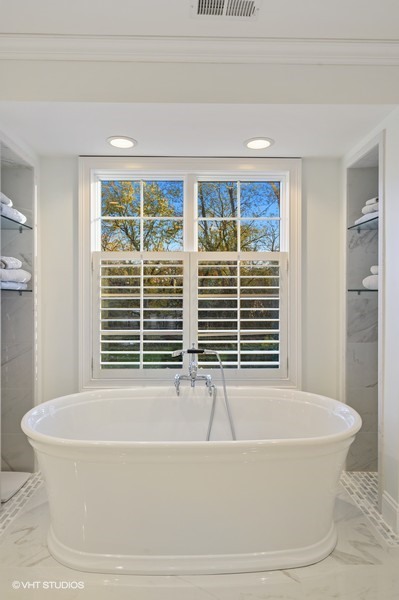 29 Woodley Road Winnetka, IL 60093 - Photo 46 of 65 a white bath tub sitting next to a window