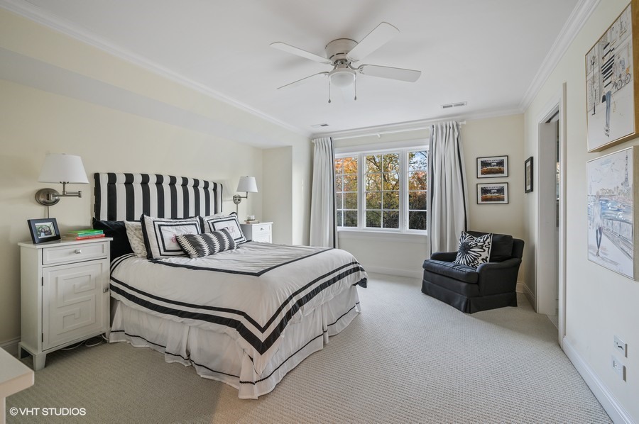 29 Woodley Road Winnetka, IL 60093 - Photo 50 of 65 a bedroom with a bed and a couch