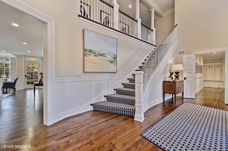 29 Woodley Road Winnetka, IL 60093 - Photo 5 of 65 a view of staircase with lots of frames and a rug
