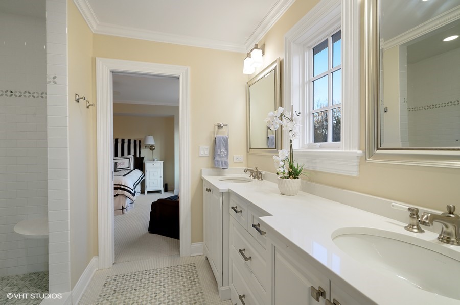 29 Woodley Road Winnetka, IL 60093 - Photo 51 of 65 a spacious bathroom with a double vanity sink a mirror and next to a window