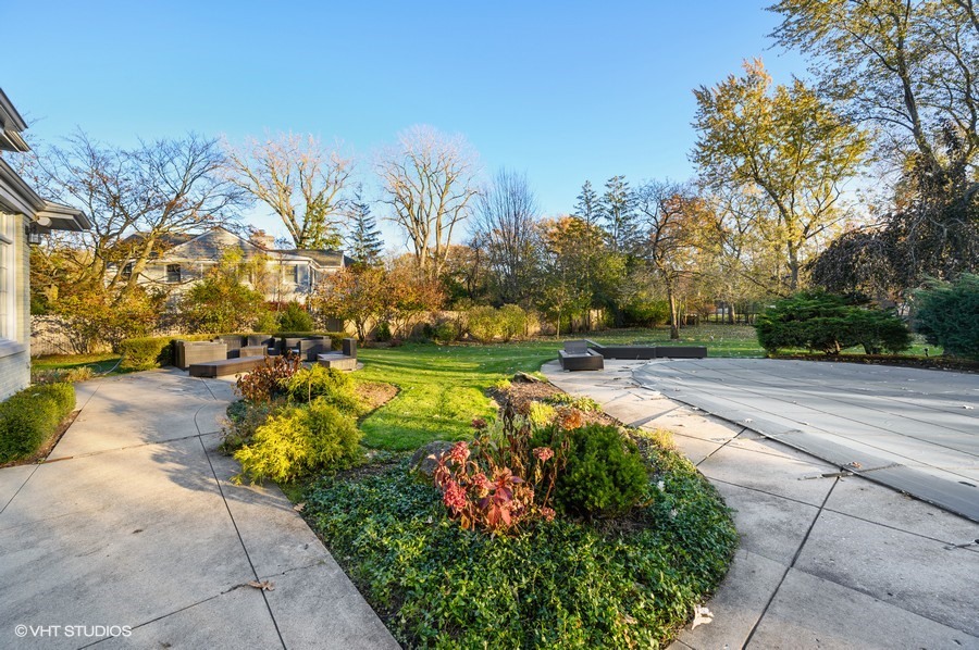 29 Woodley Road Winnetka, IL 60093 - Photo 59 of 65 a view of a swimming pool with an outdoor space and seating area