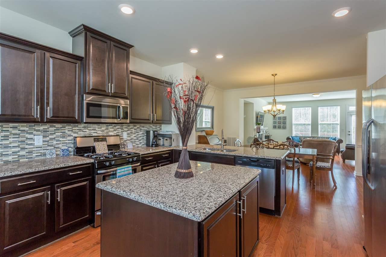 605 Edgewater Ridge Court Apex, NC 27523 - Photo 4 of 25 Large center island provides additional food-prep space and storage.