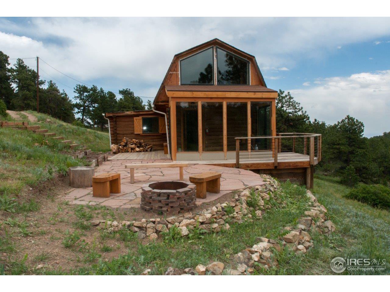 229 Jed Smith Road Ward, CO 80481 - Photo 1 of 20 a front view of a house with a yard