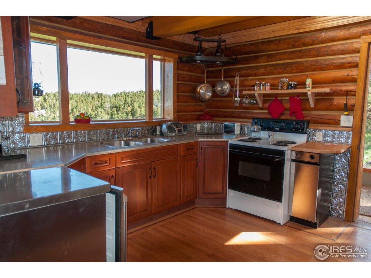 229 Jed Smith Road Ward, CO 80481 - Photo 4 of 20 a kitchen with stainless steel appliances granite countertop a stove a sink and a microwave