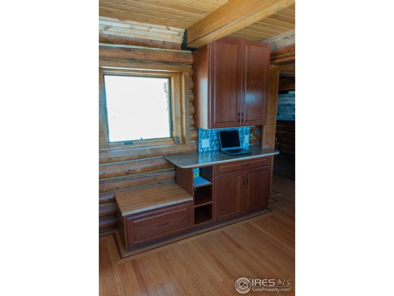 229 Jed Smith Road Ward, CO 80481 - Photo 6 of 20 a kitchen view with wooden cabinets and a window