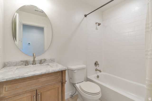 1820 West Farmhouse Flats Road Peoa, UT 84061 - Photo 31 of 79 Bathroom featuring a light-toned wood vanity, stone countertop with integrated sink, and an oval mirror