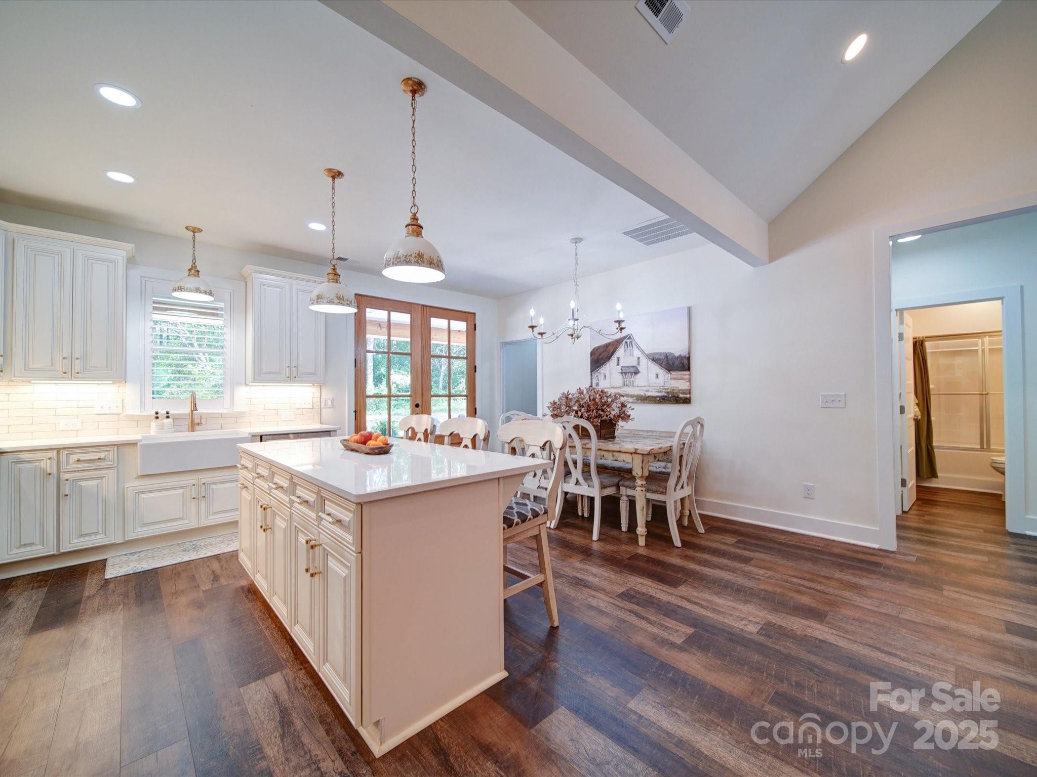 1026 Trull Hinson Road, Unit 4 Wingate, NC 28174 - Photo 7 of 14 a kitchen with stainless steel appliances a dining table chairs stove microwave and cabinets