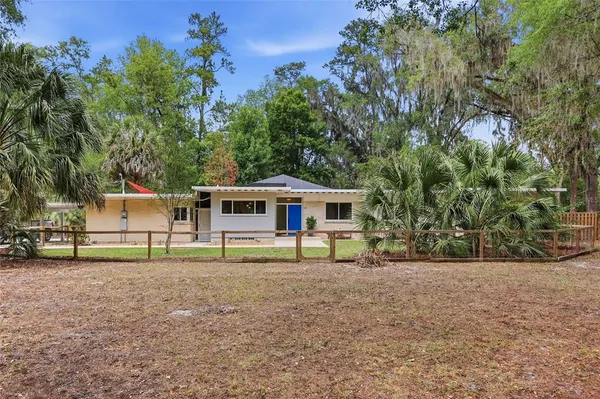 a house that has a tree in front of a house