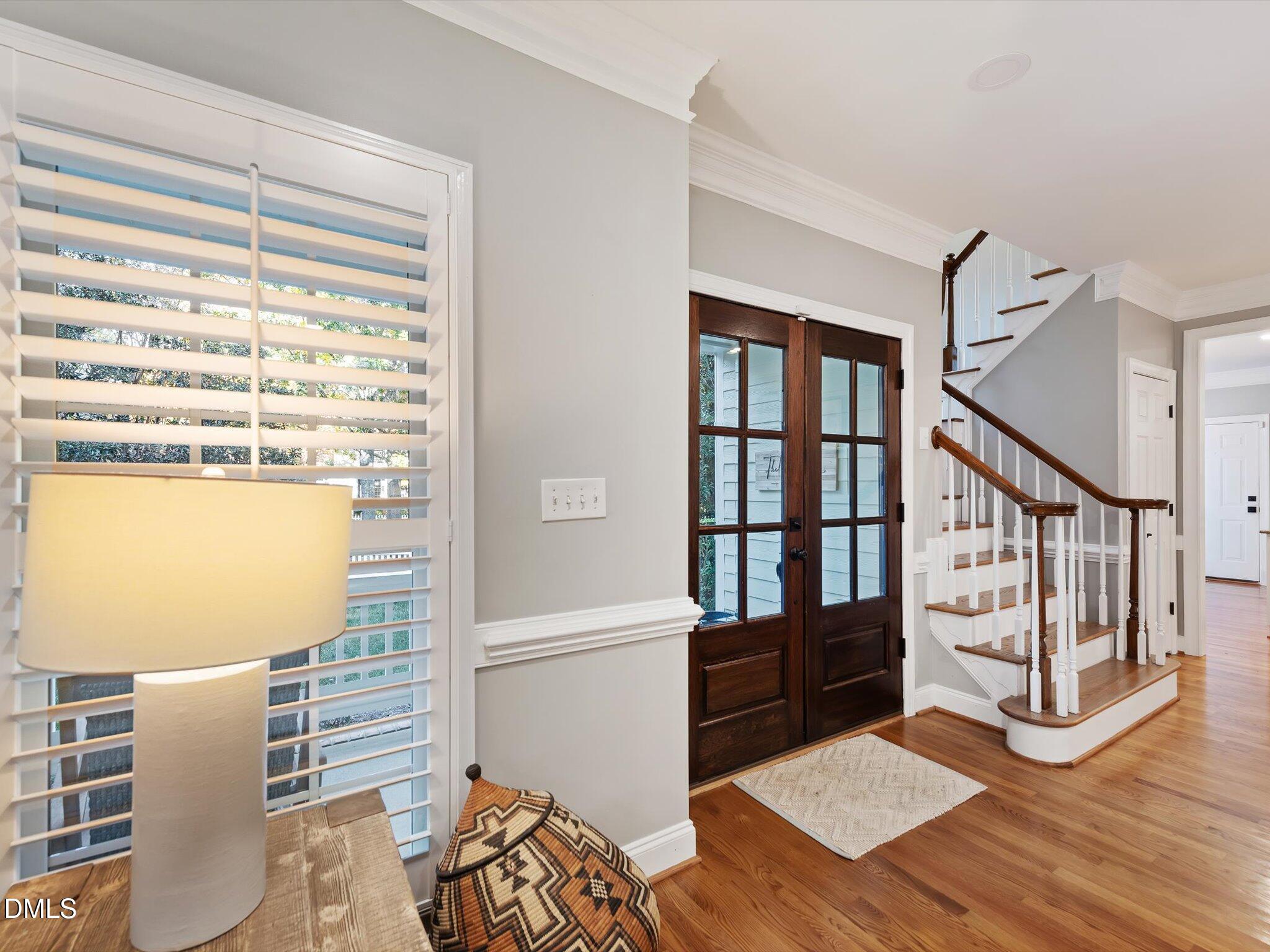 4201 Falls River Avenue Raleigh, NC 27614 - Photo 14 of 52 a view of a hallway with wooden floor and windows