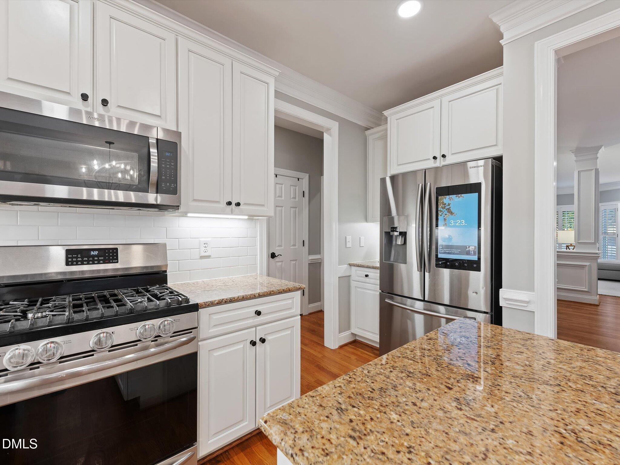 4201 Falls River Avenue Raleigh, NC 27614 - Photo 20 of 52 a kitchen with stainless steel appliances granite countertop a stove a refrigerator and a sink
