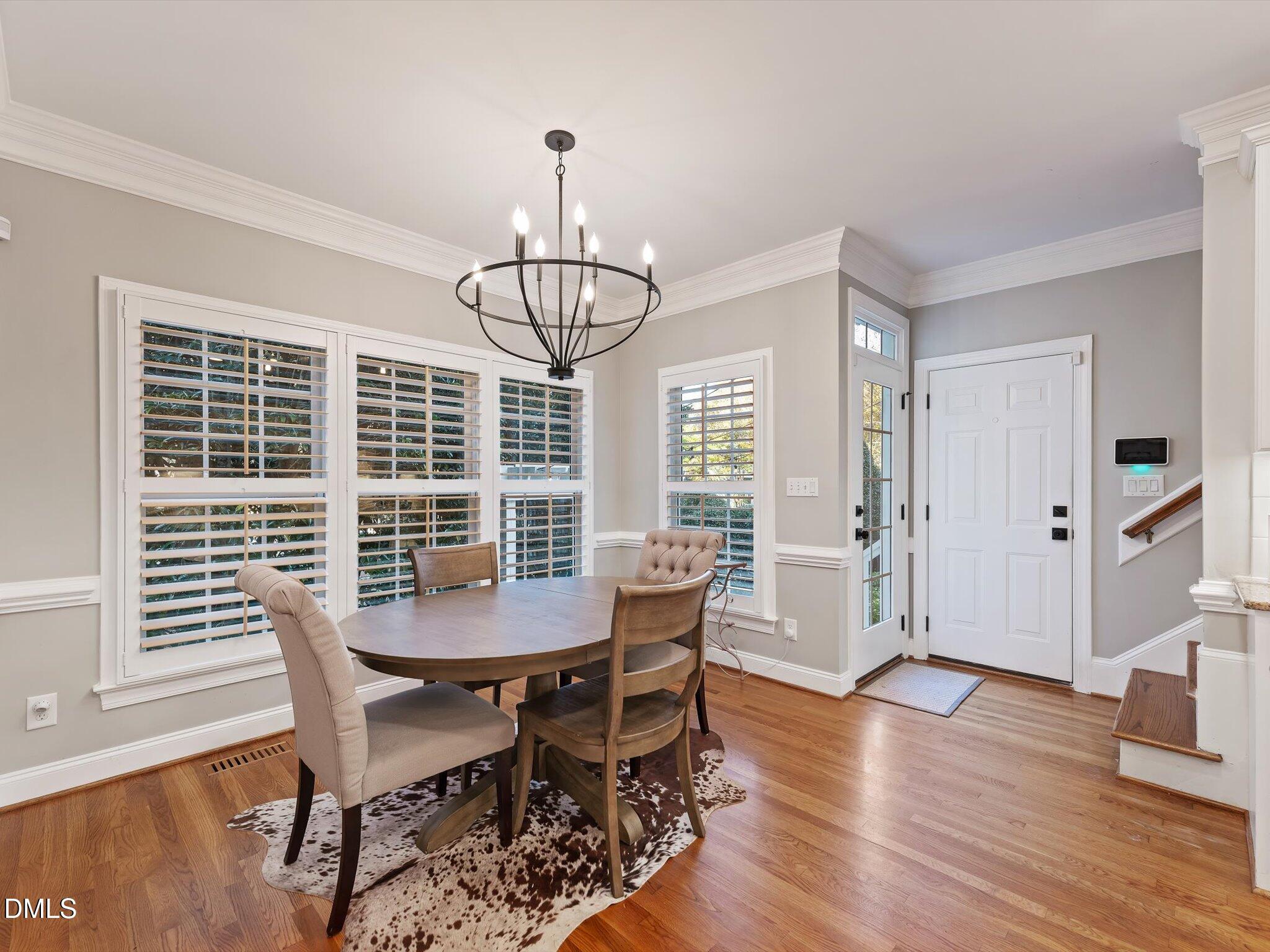 4201 Falls River Avenue Raleigh, NC 27614 - Photo 21 of 52 a view of a dining room with furniture window and wooden floor
