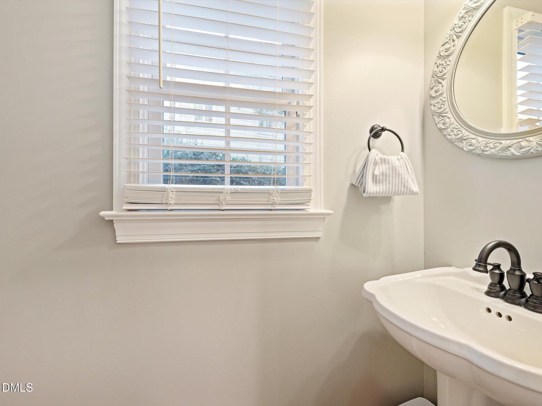 4201 Falls River Avenue Raleigh, NC 27614 - Photo 23 of 52 a bathroom with a sink and a mirror