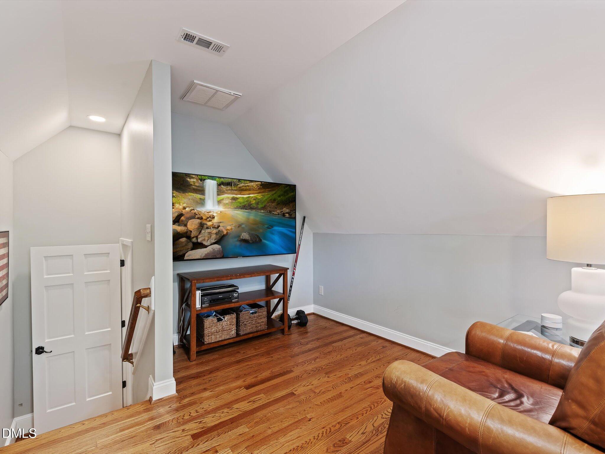 4201 Falls River Avenue Raleigh, NC 27614 - Photo 27 of 52 a living room with furniture and a flat screen tv
