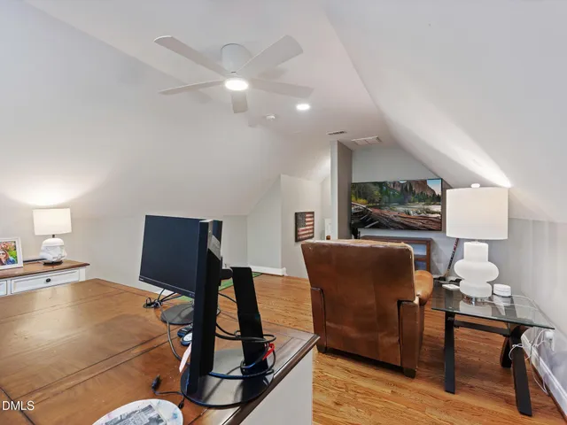 a view of a hallway with wooden floor and windows