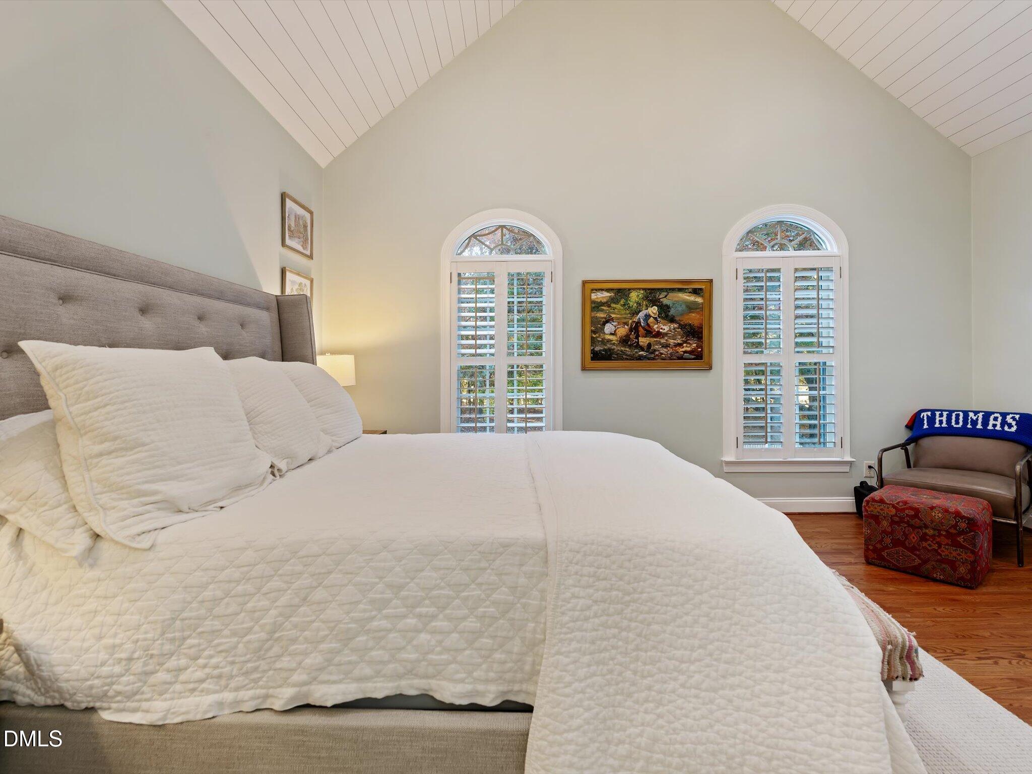 4201 Falls River Avenue Raleigh, NC 27614 - Photo 32 of 52 a bedroom with a bed and a large window