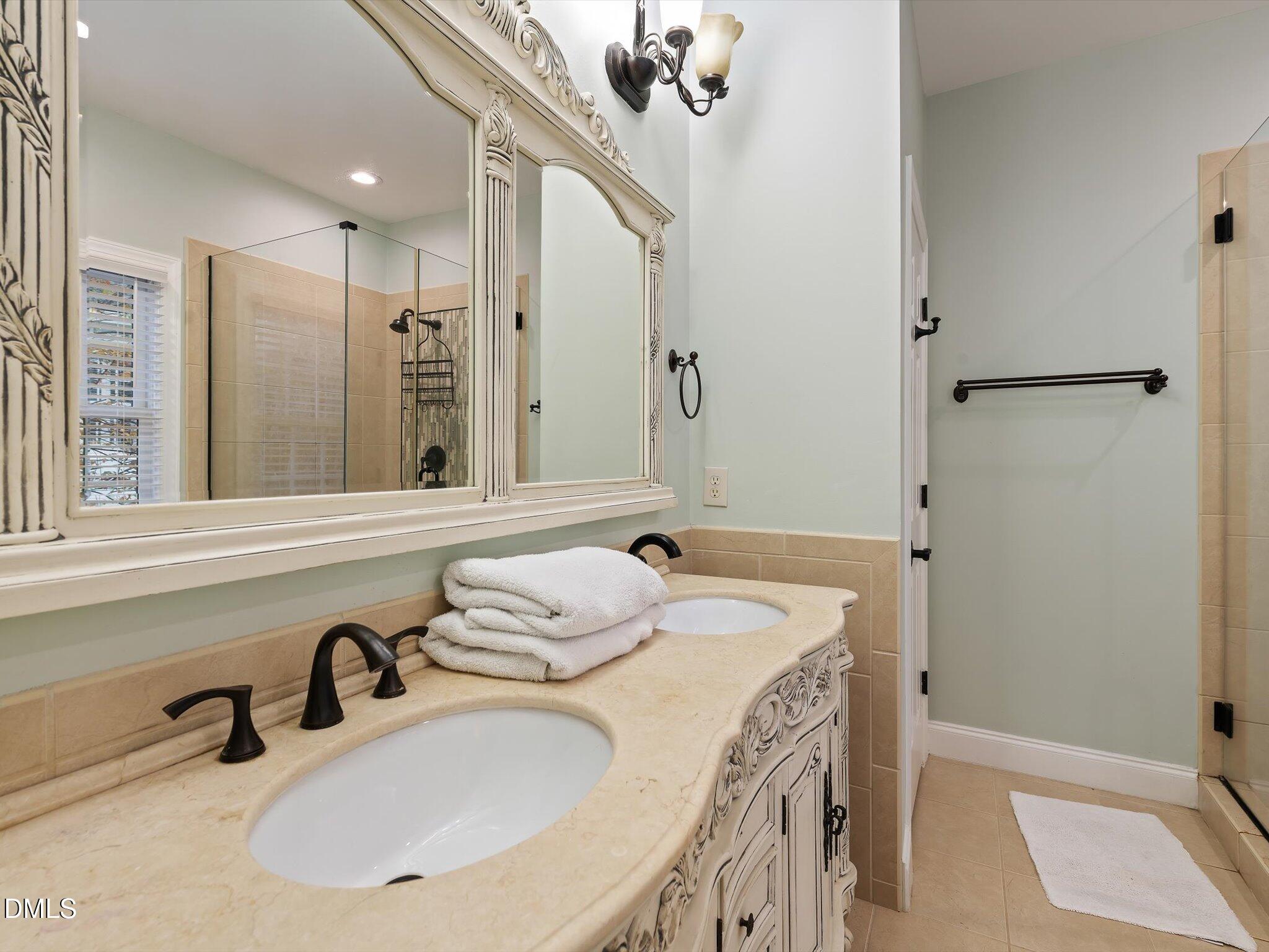 4201 Falls River Avenue Raleigh, NC 27614 - Photo 33 of 52 a bathroom with a sink and a mirror