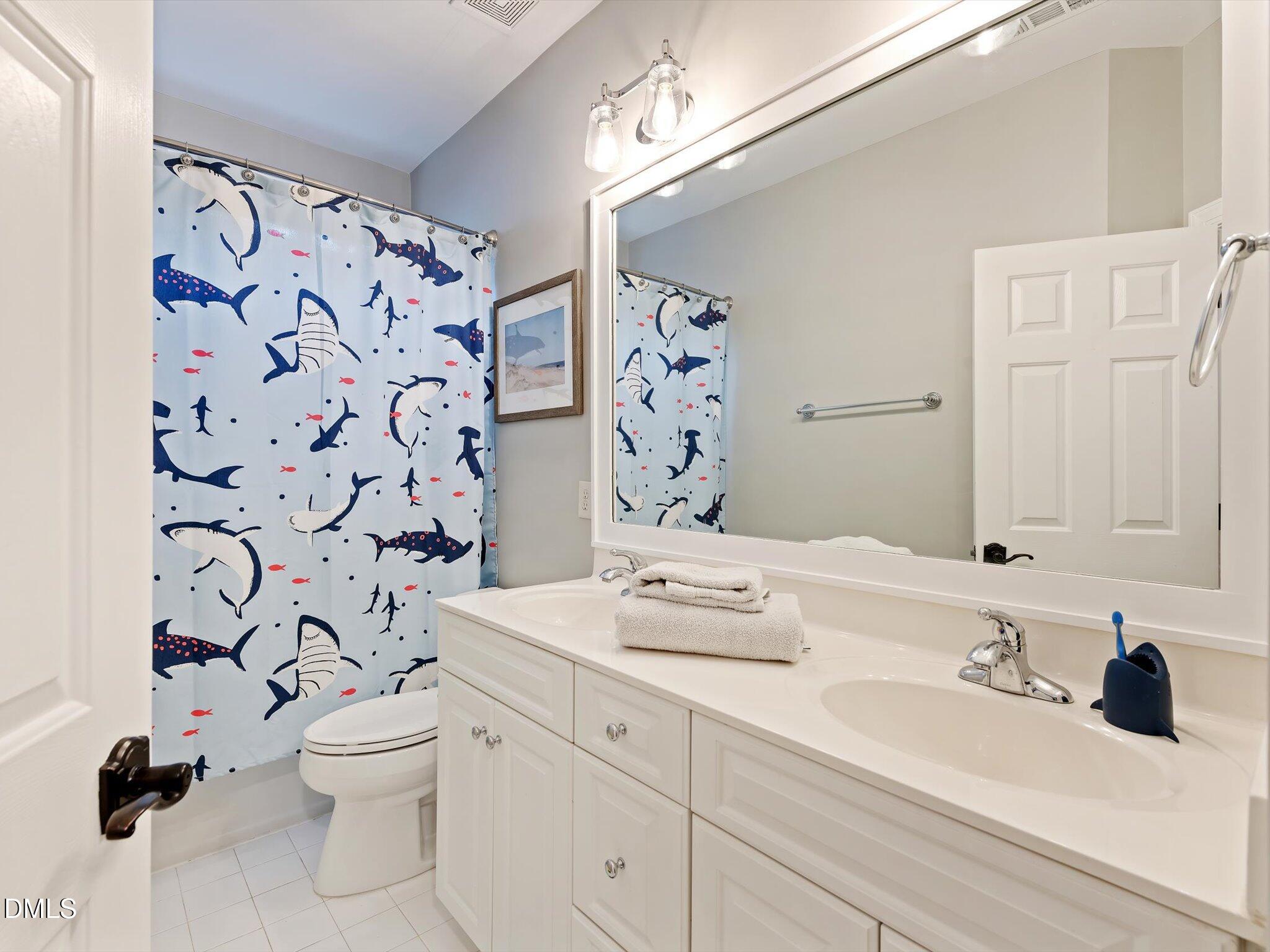 4201 Falls River Avenue Raleigh, NC 27614 - Photo 38 of 52 a bathroom with a sink toilet and shower