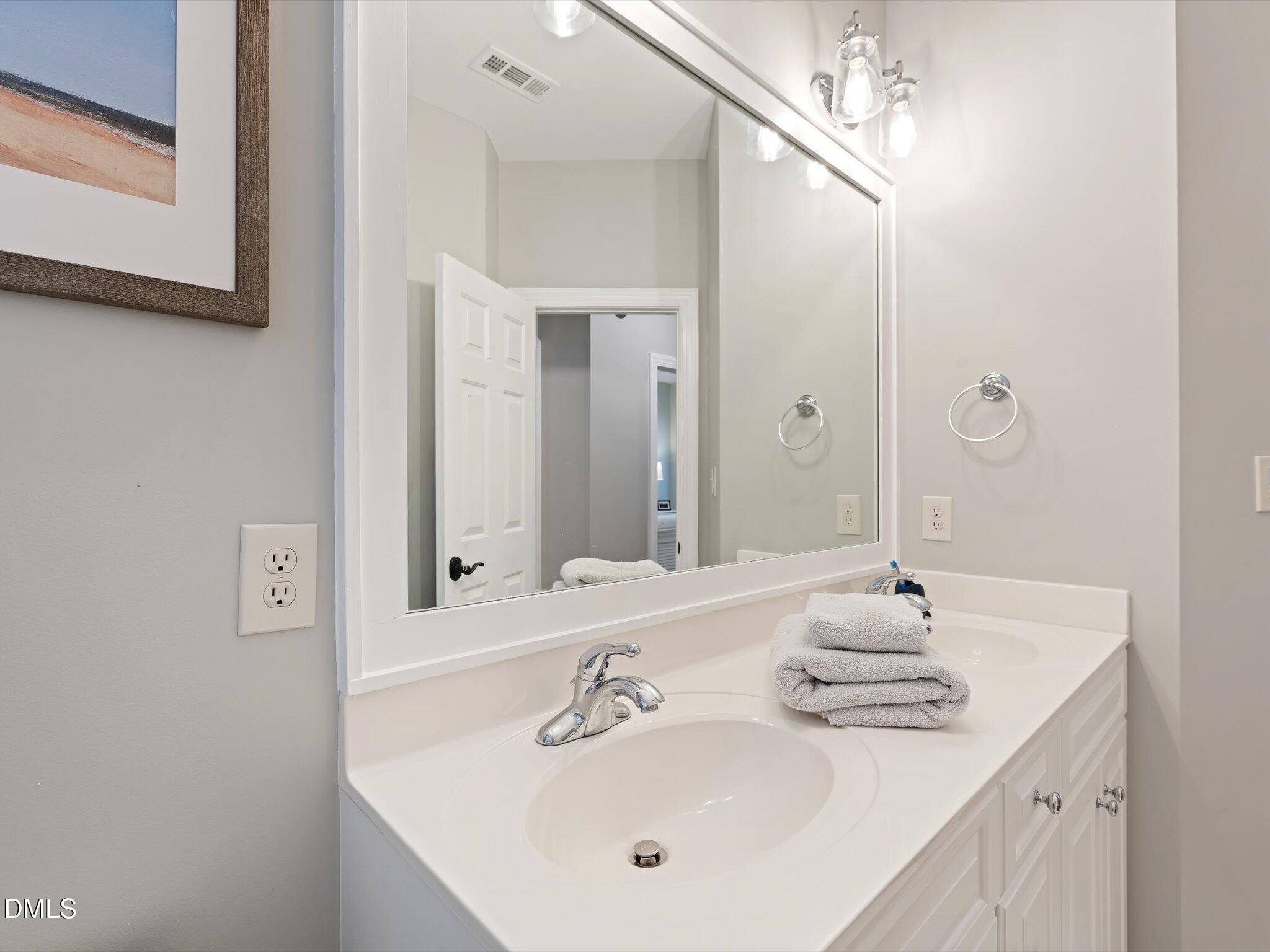 4201 Falls River Avenue Raleigh, NC 27614 - Photo 39 of 52 a bathroom with a sink and a mirror