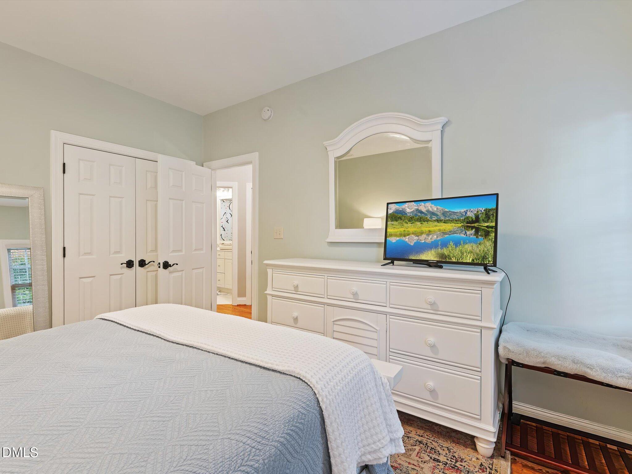 4201 Falls River Avenue Raleigh, NC 27614 - Photo 43 of 52 a bedroom with a bed and a flat screen tv