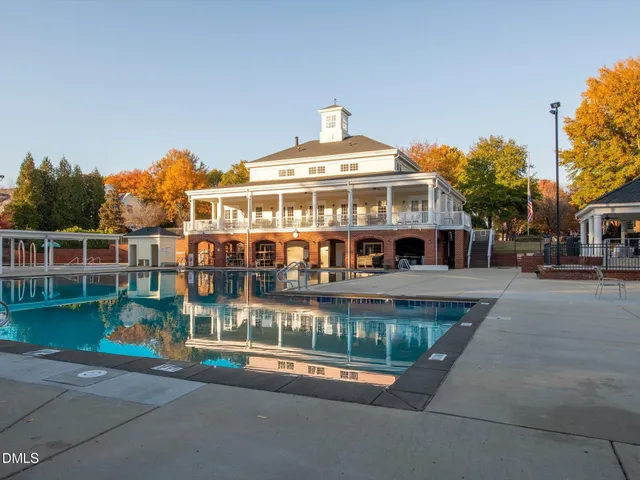 a front view of a house with a garden and plants