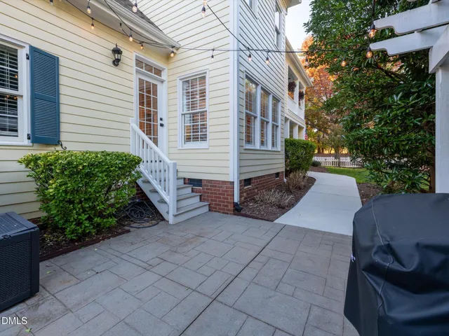 a view of backyard with outdoor seating and green space